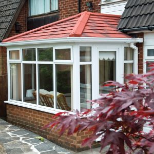 White uPVC conservatory with a red tiled roof